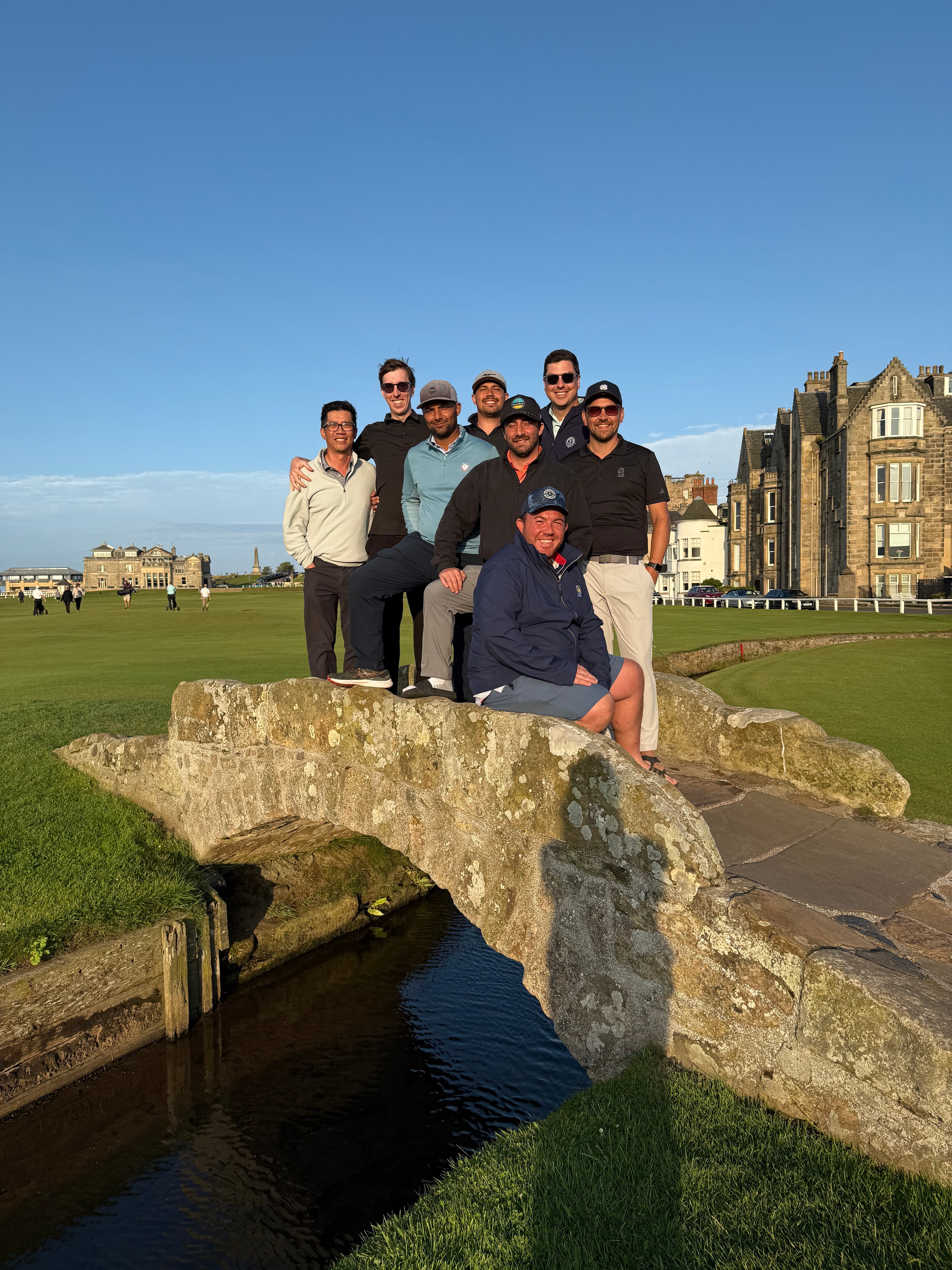 The championship group on the Swilcan Bridge at St Andrews in the evening light, 2025