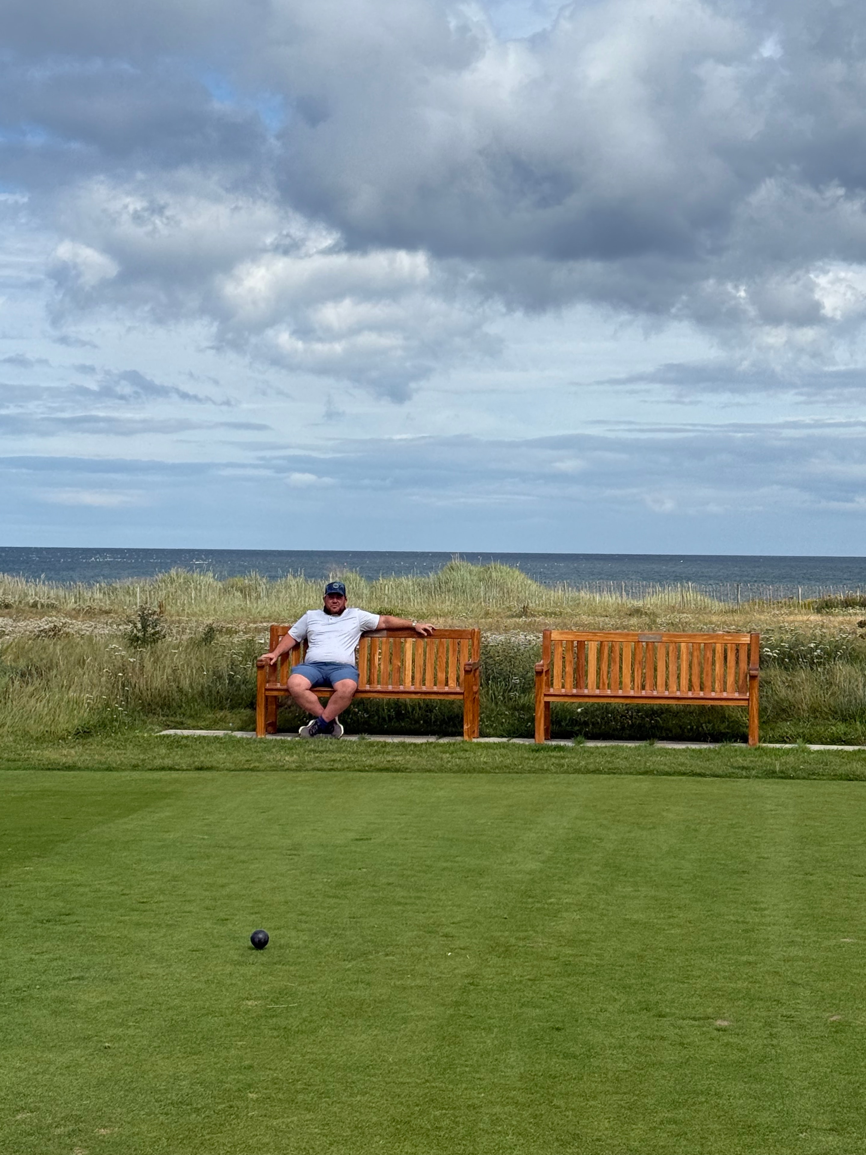 A player resting on the bench beside the links, Scotland 2025